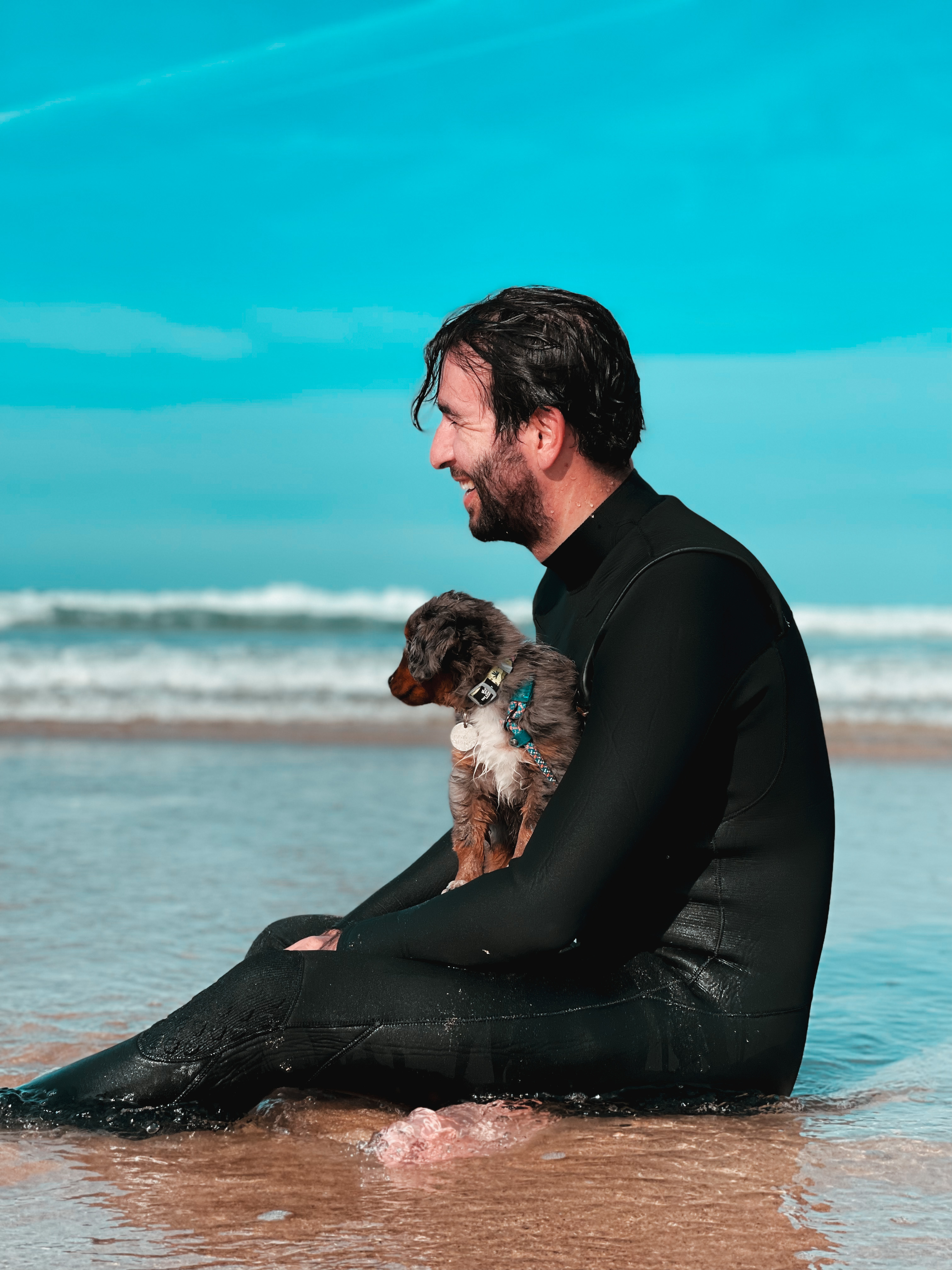 Eliot outdoors with his dog in the sea