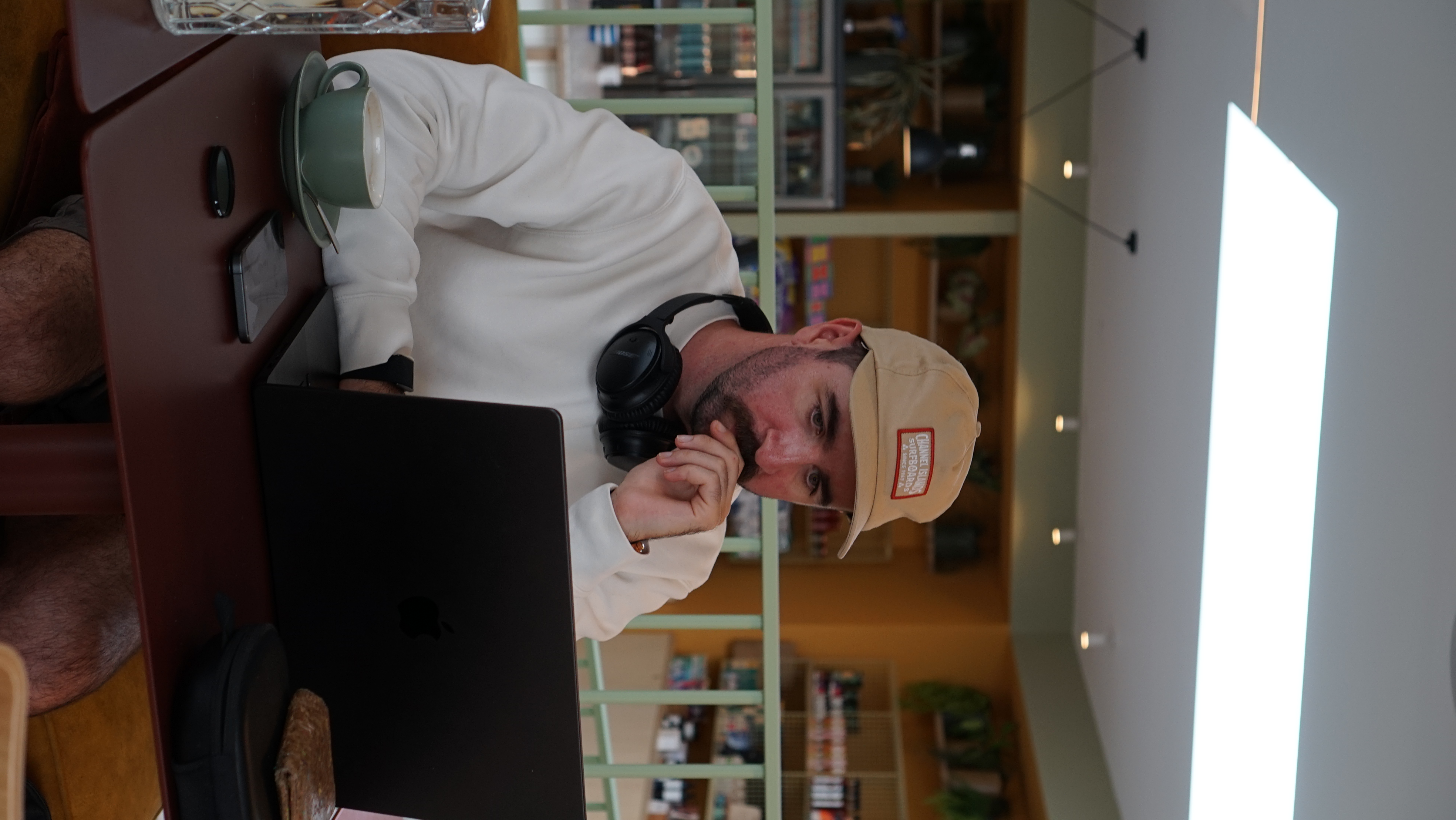 Eliot working on a laptop in a café during his agency era